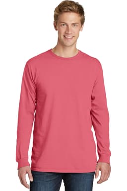 A man is wearing a long sleeve tee in a deep pink colour, featuring a simple design and a small logo.