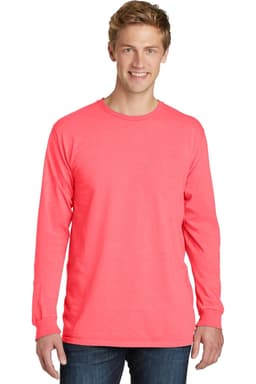 A man models a long sleeve tee in vibrant coral, featuring a logo on the front. The tee has a classic fit.