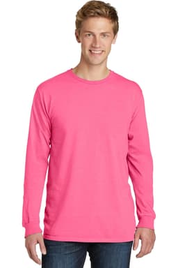 A man wearing a bright pink long sleeve t-shirt with a round neck and a logo on the front.