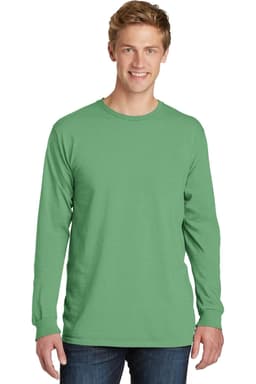 A green long sleeve tee worn by a model, featuring a logo on the front and styled with denim jeans.