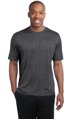 A man wearing a dark heather grey t-shirt, standing and smiling. The shirt features a logo on the front.