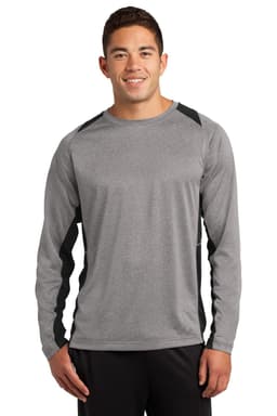 A person wearing a grey long sleeve T-shirt with black accents and a logo.