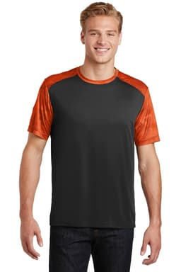 A man is wearing a Sport-Tek CamoHex Colorblock Tee in black with orange sleeves, featuring a logo on the chest.