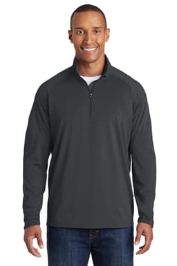 A man wearing a dark grey Sport-Tek Sport-Wick Stretch 1/2-Zip Pullover. The pullover features a slim fit and has a logo.
