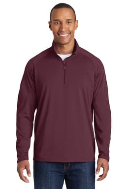 A maroon long-sleeve pullover featuring a half-zip neck and a logo. Suitable for sports and casual wear.
