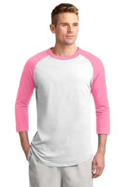 A man wearing a white and pink Sport-Tek Colorblock Raglan Jersey, featuring three-quarter sleeves and a logo.