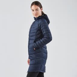 A navy women's parka jacket with a hood, featuring a quilted design and side pockets. It has a logo on it.