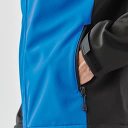 A hooded softshell jacket featuring a blue and black design, with a zippered pocket visible on the side.