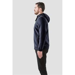 A side profile of a man wearing a navy blue fleece hoodie with a hood, featuring a logo.