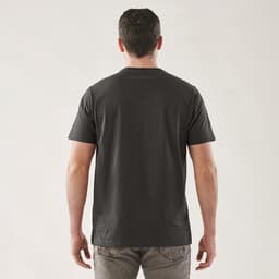 A black short sleeve tee, featuring a simple design and a logo on the back. The model stands facing away from the camera.