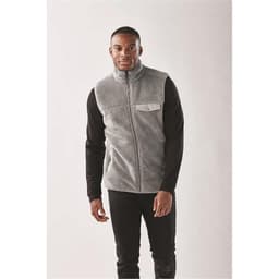 A grey Sherpa fleece vest with a zip front and a chest pocket, worn over a black long-sleeve shirt.