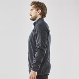 A men's full zip fleece jacket in dark navy, featuring a high collar and side pockets. It has a simple logo design.