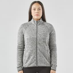 A women's full zip fleece jacket in grey with a high collar and long sleeves, featuring a logo.