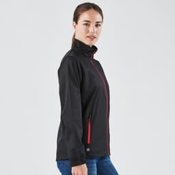 A black women's rain jacket with red accents, featuring a zippered front and side pockets, and a logo on the fabric.