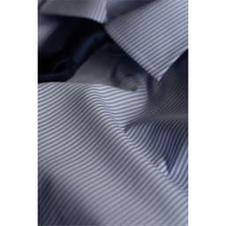 A close-up of a blue and white striped button-up shirt, featuring a collar and part of a black tie.