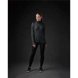 A women's Pacifica jacket in black, featuring a zip front and a modern fit, paired with black leggings and shoes.