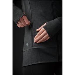 A close-up of a women's black jacket featuring a zippered pocket and a logo on the side.