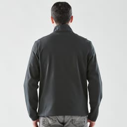 A men's softshell jacket in dark grey, featuring a collar and a sleek back design. It has a logo.