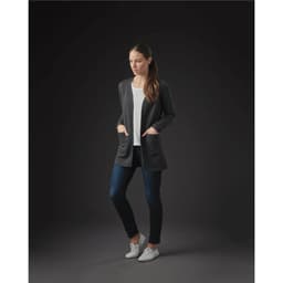 A model wearing a charcoal grey women's Chelsea open cardigan over a light top and dark jeans, featuring pockets.