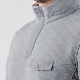 A grey men's thermal 1/4 zip pullover with a chest pocket and a soft, textured fabric. Features a logo on the chest.