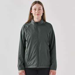 A woman wearing a dark grey full zip rain jacket with a stand collar and a logo on the chest.