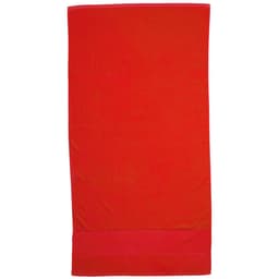 A bright red Terry Velour Towel featuring a solid design and a branded logo at the bottom.