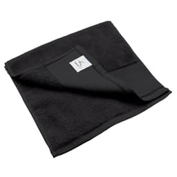 A black fitness towel, featuring a folded corner and a small branded label on its edge.