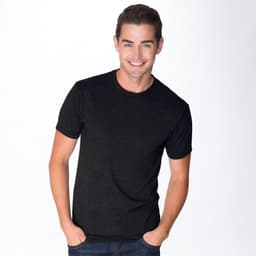A black tri-blend crew t-shirt featured on a smiling man, with a simple design and a logo present.