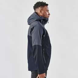 A navy blue men's rain jacket with a hood, featuring a zippered front and side pockets, alongside a model.