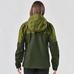 A woman wearing a dark green jacket with a hood, seen from the back. The jacket features a logo.