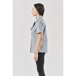 A light grey women's button-up shirt is displayed, featuring a collar and short sleeves. The shirt has a logo.