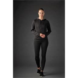 A women’s black Halifax hoody with a zip and hood, paired with black leggings, displayed on a model.