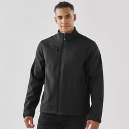 A black men's softshell jacket with a zip front, side pockets, and a chest pocket, featuring a logo.