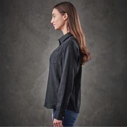 A women's long-sleeve button-up shirt in black, displayed from the side with a subtle texture and a logo.