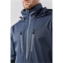 A men's lightweight shell jacket in navy blue featuring a hood and two zippered pockets. It includes branding.