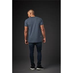 A men's crew neck tee featuring a blue and white striped design, paired with dark jeans. The model is viewed from the back.
