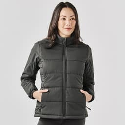 A women's puffer jacket in dark grey with a zip front, featuring side pockets and a high collar, with branding.