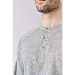 A grey men's henley shirt featuring a button-up neckline, with contrasting raglan sleeves and a subtle logo.