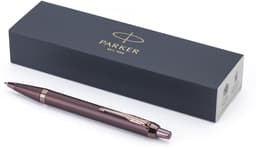 A Parker IM Monochrome PVD ballpoint pen in a sleek bronze finish, resting beside its branded box.
