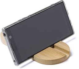 A bamboo phone and tablet holder in a natural finish, supporting a smartphone at an angle.