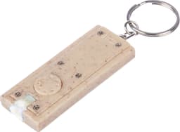 A wheatstraw key holder in a light beige colour with a round button and a metal ring for attachment.