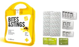 A bright yellow first aid kit titled "Bites&Stings" containing waterproof plasters, insect repellent, and aloe vera.