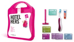 A pink travel kit containing assorted toiletries, including shaving cream, shampoo, and aloe vera, with a branded case.
