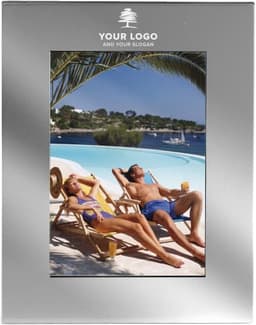 A silver aluminium photo frame featuring a tropical scene with two people relaxing by a pool.