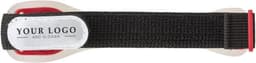 A black silicone arm strap with red detailing and a logo tag on one side.