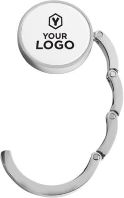 A metal bag hook in silver, featuring a circular attachment with a logo.