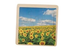 A wooden nine-piece puzzle featuring a vibrant sunflower field under a blue sky.