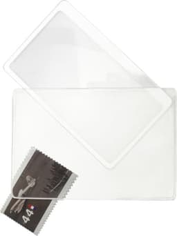 A clear PVC magnifying glass with a rectangular shape, placed above a stamp featuring an image of an aircraft.