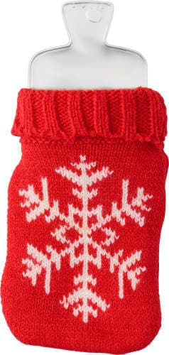 A red hot pad shaped like a warm water bag, featuring a white snowflake design on a knitted cover.