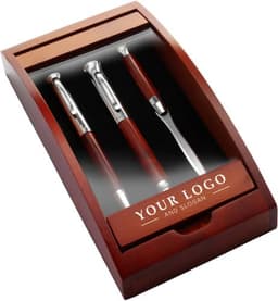 A Rosewood writing set in a wooden presentation box, featuring two pens and a letter opener. Silver accents shine against the dark wood.